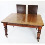 An Edwardian mahogany extending dining table, the rectangular top with canted corners, raised upon