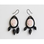A pair of Victorian cameo set jet coloured earrings, each comprising an oval carved shell cameo