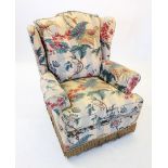 An early 20th century wing back easy chair, covered in striped foliate fabric, the padded wing backs