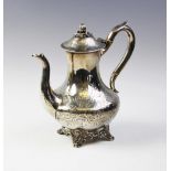 A Victorian silver coffee pot by John Wellby, London 1843, of baluster form on four scrolling