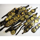 A large collection of 19th century and later horse brasses and leather straps, to include pierced