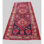 A large North Iranian runner, with cross medallion design in vibrant colours, 324cm x 121cm