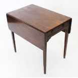 An early 19th century mahogany Pembroke table, with a single frieze drawer raised upon legs of