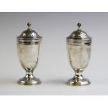A pair of George V silver pepperettes by George Nathan & Ridley Hayes, Chester 1911, of plain