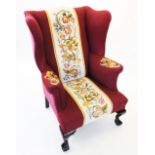 A George III style wing back fireside armchair, late 19th/early 20th century, in burgundy fabric