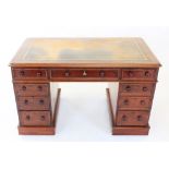 A Victorian mahogany twin pedestal desk, the rectangular moulded top inset with a gilt tooled