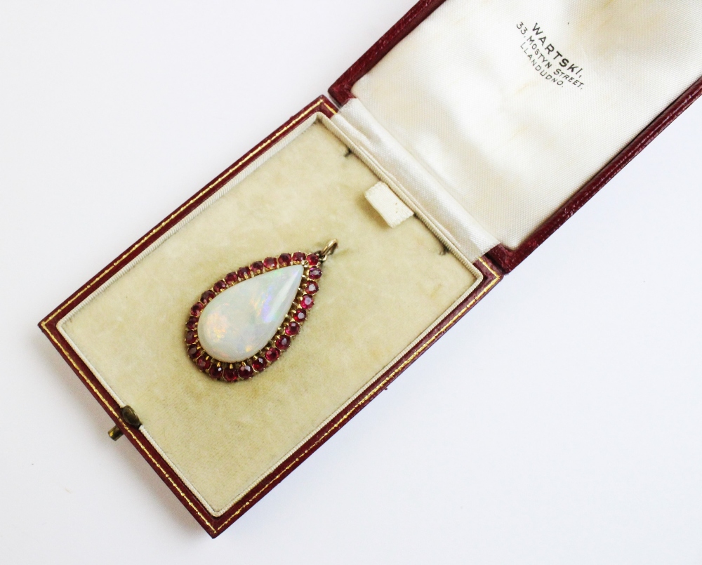 An opal and untested ruby set pendant within a fitted Wartski case, the pear shaped opal - Image 5 of 5