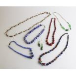 A blue millefiori glass bead necklace, comprising forty-four graduated polished beads, simple hook