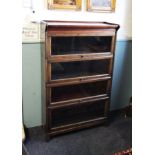 An early 20th century oak Globe Wernicke type stacking bookcase, the over hanging pediment above