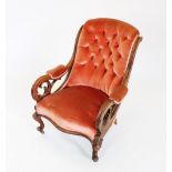 A mid 19th century mahogany framed open armchair, the padded button back flanked by channelled