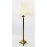 An early 20th century brass standard lamp, with a reeded Corinthian column upon a stepped plinth
