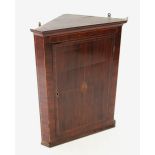 A George III mahogany straight front hanging corner cupboard, the single door centred with an inlaid