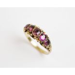 A Victorian five stone amethyst ring, comprising five graduated cushion cut amethysts measuring