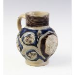 A German salt glazed stoneware jug, late 17th century, the jug with applied octagonal medallion (