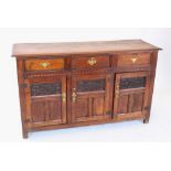 A 19th century oak dresser base/sideboard, the rectangular thumb moulded top above three invert