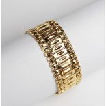 An 18ct yellow gold bracelet, comprising thirty-seven rectangular panels with brick-link borders,