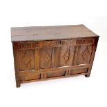 An early 18th century oak coffer, the rectangular moulded three plank top above a nulled frieze