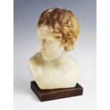 A late 19th century French wax bust, modelled facing dexter, signed verso, raised on a rectangular