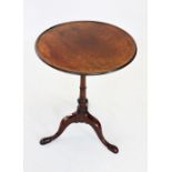 A George III mahogany tripod lamp table, the circular tray top with a moulded raised rim, upon a