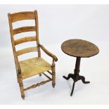 A George III oak tripod table, the circular tilt top on a ring turned tapering column extending to