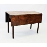 An early 19th century oak drop leaf table, the rectangular top raised upon legs of tapering square