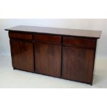 A mid 20th century Danish design rosewood sideboard by Dyrlund, the rectangular top above three
