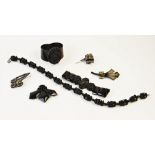 A selection of jet and jet coloured costume jewellery, to include a carved bead necklace, 38.5cm