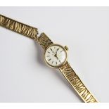 A lady's vintage 9ct gold Omega wristwatch, the cream circular dial with baton markers, set to a