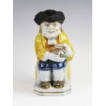 A Staffordshire pearlware toby jug, probably early 19th century, the jug of typical form with yellow