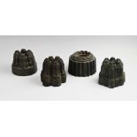 Four 19th century copper estate jelly moulds, each of varying form to include three castellated