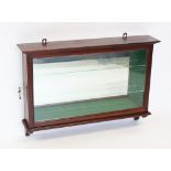 An early 20th century mahogany wall display cabinet, with a single lockable door enclosing a