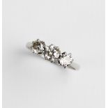 A diamond three-stone ring, the central round brilliant cut diamond weighing approx. 0.45 carat,