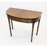 A George III mahogany and satinwood cross banded folding games table, the 'D' shaped hinged top