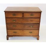 A George III honey oak chest of drawers, the rectangular top with a reeded edge, above two short and