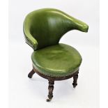 A mid 19th century mahogany and green leather desk chair, the tapered and padded wing backs with