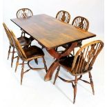 A mid 20th oak refectory table, the rectangular slab top on a pair of 'X' shaped trestle type