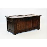 A late 17th/early 18th century oak coffer, the associated three panel top enclosing a fitted