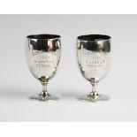A pair of Edwardian silver trophy cups by Goldsmiths & Silversmiths Co, London 1907, one engraved ?