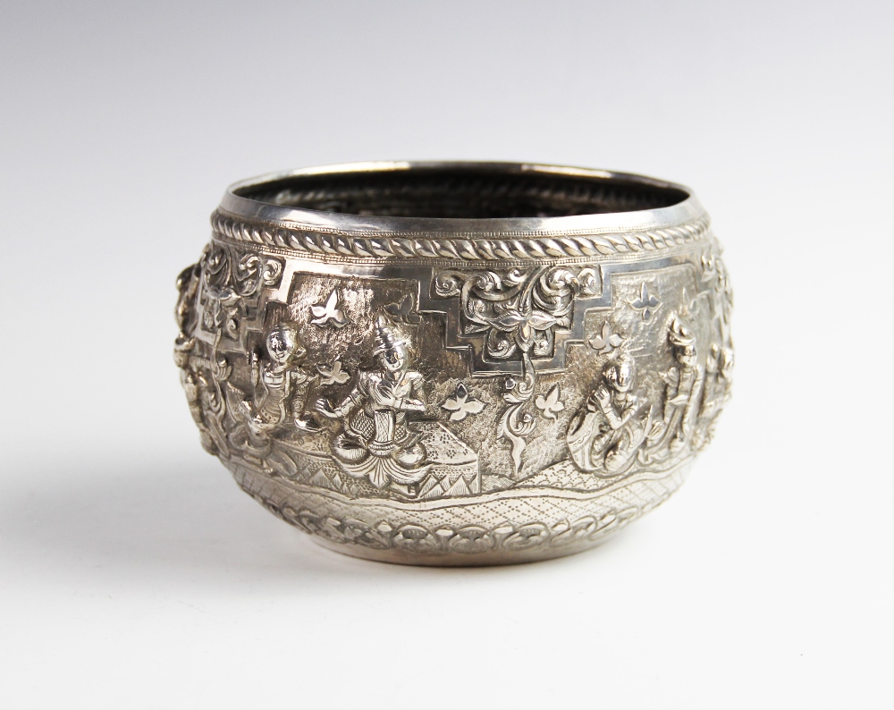 A late 19th/early 20th century Burmese white metal bowl, of circular form decorated in high relief