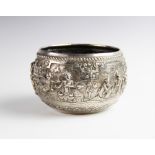 A late 19th/early 20th century Burmese white metal bowl, of circular form decorated in high relief