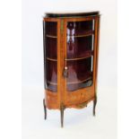 A Louis XVI style kingwood vitrine, mid 20th century, the glazed serpentine door with lower