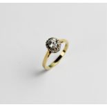 A zircon and diamond 18ct gold cluster ring, comprising a central round brilliant cut white zircon