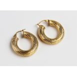 A pair of 9ct gold hoop earrings, of circular form with reeded decoration, with hinged back