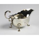 A George V silver sauce boat and ladle by Martin Hall & Co Ltd, Sheffield 1918, the sauce boat