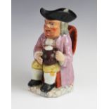 A Staffordshire pearlware toby jug, probably early 19th century, the jug of typical form with purple