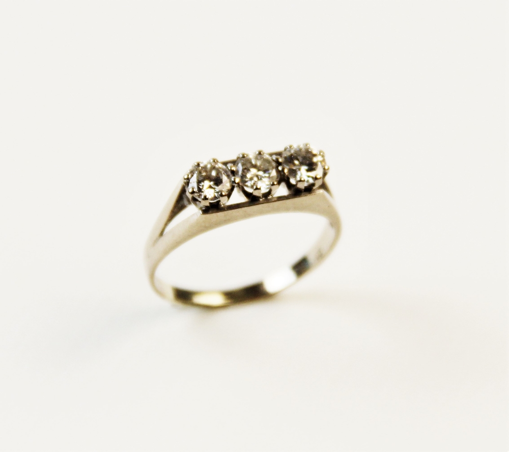 A diamond three-stone ring, each round brilliant cut diamond weighing approximately 0.25 carats,