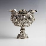 An Indian silver pedestal bowl, with shaped rim on knopped stem and domed foot, with elaborate