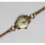 A lady's vintage Omega 9ct gold wristwatch, the round cream dial with baton markers set to a plain