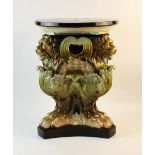 A large continental majolica jardinière stand, 19th/20th century, modelled as three winged lions