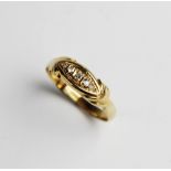 An Edwardian diamond and 18ct gold ring, comprising five graduated mine cut diamonds set to a